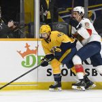 
              Nashville Predators defenseman Alexandre Carrier (45) moves the puck ahead of Florida Panthers left wing Mason Marchment during the first period of an NHL hockey game Saturday, April 9, 2022, in Nashville, Tenn. (AP Photo/Mark Zaleski)
            