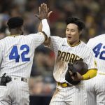 
              San Diego Padres' Ha-Seong Kim, center, celebrates after scoring with Jurickson Profar, left, during the fifth inning of a baseball game against the Atlanta Braves in San Diego, Friday, April 15, 2022. (AP Photo/Kyusung Gong)
            