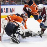 
              Colorado Avalanche's Artturi Lehkonen (62) is stopped by Edmonton Oilers goalie Mikko Koskinen (19) during the third period of an NHL hockey game Saturday, April 9, 2022, in Edmonton, Alberta. (Jason Franson/The Canadian Press via AP)
            