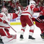 
              Detroit Red Wings goaltender Alex Nedeljkovic (39) gloves a shot while defenseman Gustav Lindstrom (28) guards Carolina Hurricanes center Seth Jarvis (24) during the second period of an NHL hockey game Thursday, April 14, 2022, in Raleigh, N.C. (AP Photo/Chris Seward)
            