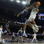 
              Kansas' David McCormack (33) shoots over Villanova's Jermaine Samuels (23) during the first half of a college basketball game in the semifinal round of the Men's Final Four NCAA tournament, Saturday, April 2, 2022, in New Orleans. (AP Photo/David J. Phillip)
            