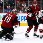
              New Jersey Devils center Jesper Boqvist, right, sends the puck past Arizona Coyotes goaltender Karel Vejmelka, left, for a goal as Coyotes left wing Matias Maccelli (63) watches during the second period of an NHL hockey game Tuesday, April 12, 2022, in Glendale, Ariz. (AP Photo/Ross D. Franklin)
            
