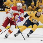 
              Calgary Flames' Mikael Backlund (11) moves the puck against Nashville Predators' Tanner Jeannot (84) in the second period of an NHL hockey game Tuesday, April 26, 2022, in Nashville, Tenn. (AP Photo/Mark Humphrey)
            