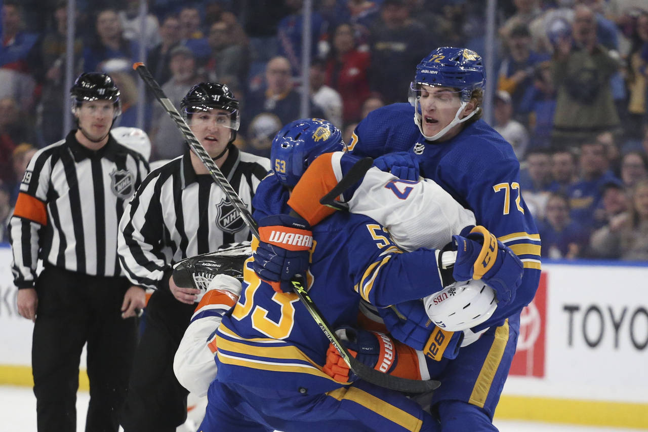 Buffalo Sabres right wing Tage Thompson (72) tries to pull New York Islanders left wing Matt Martin...