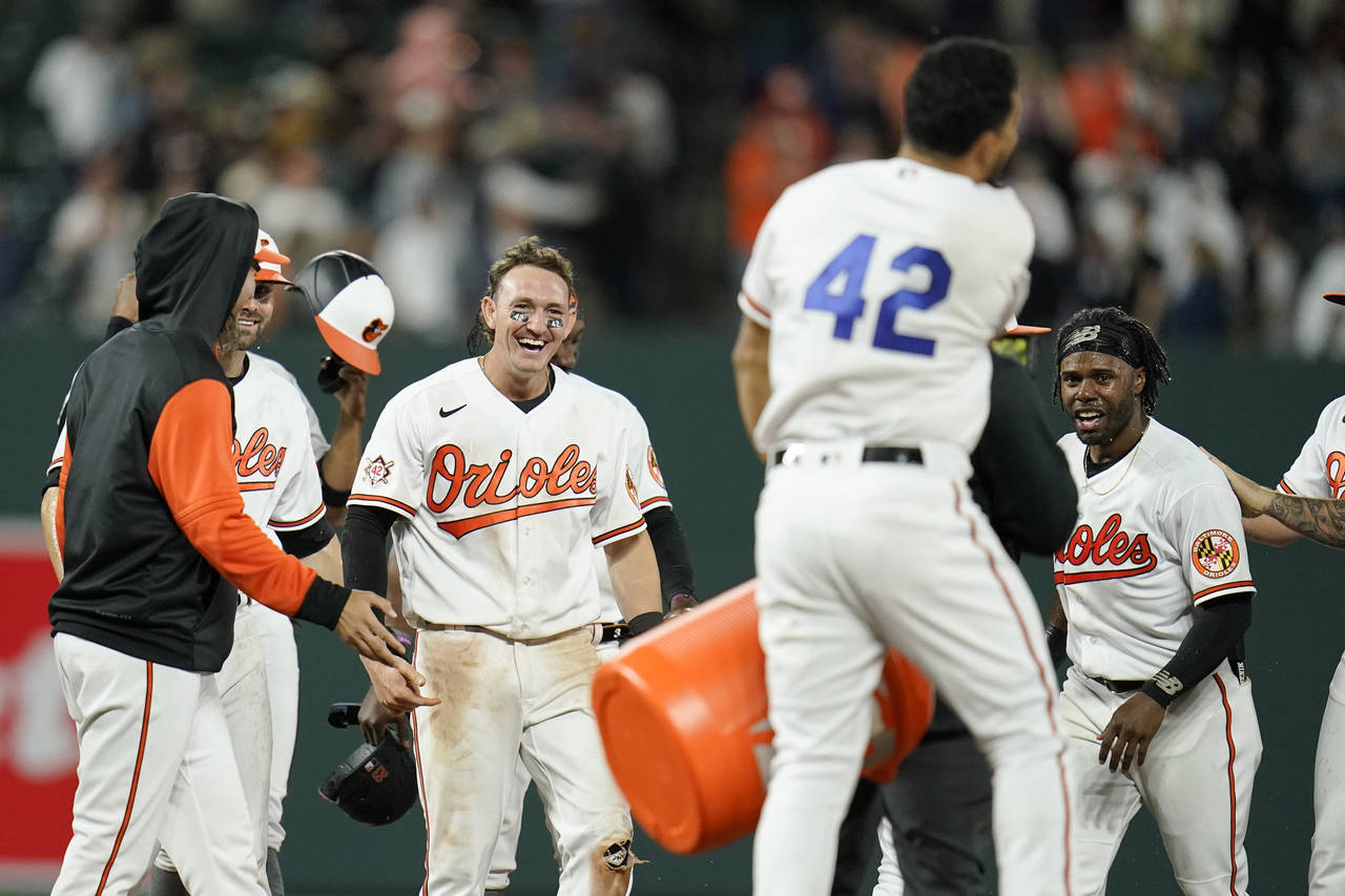 Baltimore Orioles' Austin Hays, center left, celebrates with teammates after he scored the winning ...