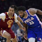 
              Philadelphia 76ers center Joel Embiid, right, drives against Cleveland Cavaliers center Moses Brown in the second half of an NBA basketball game, Sunday, April 3, 2022, in Cleveland. (AP Photo/David Dermer)
            