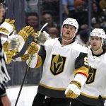 
              Vegas Golden Knights' Jack Eichel (9) is congratulated after scoring against the Seattle Kraken as teammate Ben Hutton follows in the second period of an NHL hockey game Friday, April 1, 2022, in Seattle. (AP Photo/Elaine Thompson)
            
