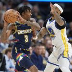 
              Denver Nuggets guard Bones Hyland, left, looks to pass the ball as Golden State Warriors guard Gary Payton II defends in the first half of Game 4 of an NBA basketball first-round Western Conference playoff series, Sunday, April 24, 2022, in Denver. (AP Photo/David Zalubowski)
            