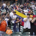 
              Venezuelan baseball fans cheer for Detroit Tigers designated hitter Miguel Cabrera as he is interviewed after the ninth inning of the first baseball game of a doubleheader against the Colorado Rockies, Saturday, April 23, 2022, in Detroit. (AP Photo/Carlos Osorio)
            