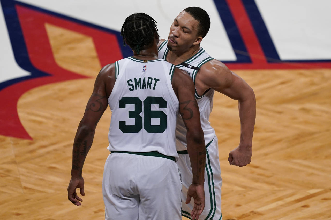 Boston Celtics forward Grant Williams, right, celebrates with guard Marcus Smart (36) during the se...