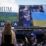 
              Yulia Holiyat, 11, of Brooklyn, sings the Ukrainian national anthem in honor of the country's struggle in their war with Russia before the New York Yankees opening day baseball game against the Boston Red Sox, Friday, April 8, 2022, in New York. (AP Photo/John Minchillo)
            