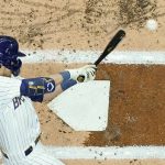 
              Milwaukee Brewers' Christian Yelich hits a single during the first inning of a baseball game against the Chicago Cubs Saturday, April 30, 2022, in Milwaukee. (AP Photo/Morry Gash)
            