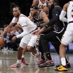 
              Brooklyn Nets' Bruce Brown, second from left, fouls Cleveland Cavaliers' Darius Garland, left, during the first half of the opening basketball game of the NBA play-in tournament Tuesday, April 12, 2022, in New York. (AP Photo/Seth Wenig)
            