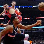 
              Milwaukee Bucks forward Giannis Antetokounmpo, front, and Chicago Bulls center Nikola Vucevic, back, go for the ball during the first half of an NBA basketball game Tuesday, April 5, 2022, in Chicago. (AP Photo/David Banks)
            