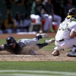 
              Cleveland Guardians' Owen Miller, left, slides safely home as Oakland Athletics catcher Austin Allen, right, waits for the throw on a double hit by Richie Palacios during the ninth inning of a baseball game in Oakland, Calif., Saturday, April 30, 2022. (AP Photo/Jed Jacobsohn)
            