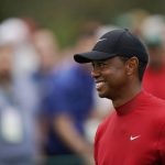 
              FILE - Tiger Woods smiles as he walks off the seventh tee during the final round for the Masters golf tournament, April 14, 2019, in Augusta, Ga. Woods hasn't played since the November 2020 Masters because of a car crash in Los Angeles in February 2021 that badly damaged his right leg. His only competition since then was riding a cart and playing a scramble format with his 12-year-old son in the PNC Championship in December. The Masters is scheduled for April 7-10, 2022 at Augusta National in Augusta, Ga. (AP Photo/David J. Phillip)
            