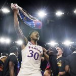 
              Kansas guard Ochai Agbaji celebrates after their win against North Carolina in a college basketball game at the finals of the Men's Final Four NCAA tournament, Monday, April 4, 2022, in New Orleans. (AP Photo/Brynn Anderson)
            