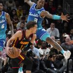 
              Atlanta Hawks guard Trae Young (11) is defended by Charlotte Hornets guard Terry Rozier (3) as he looks for an open man in the second half of an NBA play-in basketball game Wednesday, April 13, 2022, in Atlanta. (AP Photo/John Bazemore)
            