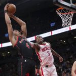 
              Toronto Raptors' Scottie Barnes (4) takes a rebound from Houston Rockets' Kevin Porter Jr. during the first half of an NBA basketball game in Toronto on Friday, April 8, 2022. (Chris Young/The Canadian Press via AP)
            