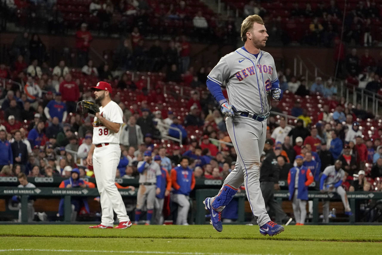 New York Mets' Pete Alonso, right, takes his base after being hit by a pitch from St. Louis Cardina...