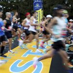 
              FILE - Runners cross the starting line of the 125th Boston Marathon, Monday, Oct. 11, 2021, in Hopkinton, Mass. The Boston Marathon returns, Monday, April 18, 2022. (AP Photo/Mary Schwalm, File)
            