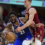 
              Philadelphia 76ers center Joel Embiid, left, drives against Cleveland Cavaliers forward Lauri Markkanen, right, in the second half of an NBA basketball game, Sunday, April 3, 2022, in Cleveland. (AP Photo/David Dermer)
            