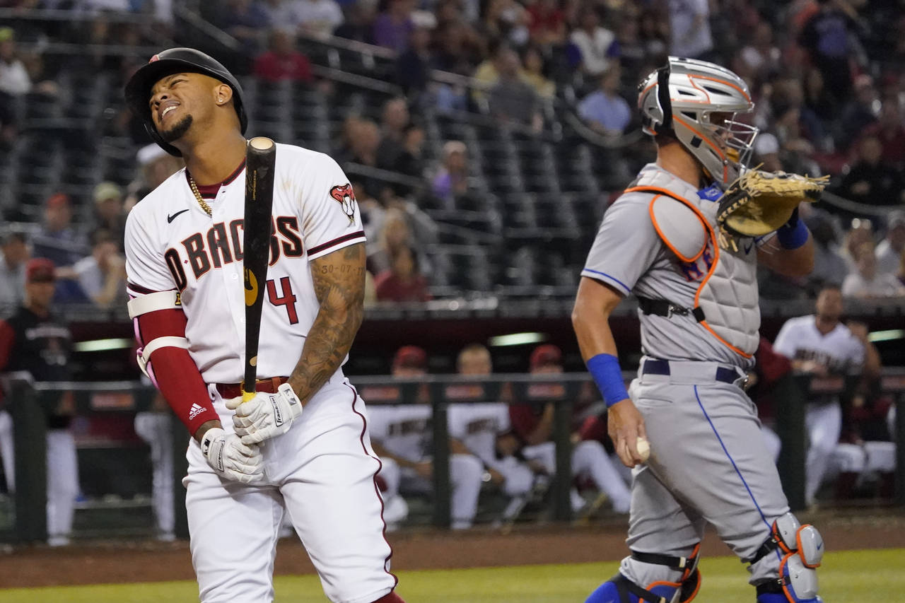 Ketel Marte of the Arizona Diamondbacks reacts after being hit by