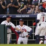 
              Atlanta Braves' Ozzie Albies (1) is greeted at the dugout by coach Walt Weiss, left, manager Brian Snitker and shortstop Dansby Swanson after hitting a home run during the first inning of the team's baseball game against the Florida Marlins on Saturday, April 23, 2022, in Atlanta. (AP Photo/John Bazemore)
            
