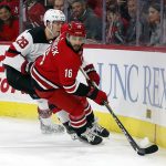 
              Carolina Hurricanes' Vincent Trocheck (16) controls the puck near New Jersey Devils' Damon Severson (28) during the second period of an NHL hockey game in Raleigh, N.C., Thursday, April 28, 2022. (AP Photo/Karl B DeBlaker)
            