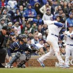 
              Chicago Cubs' Ian Happ hits a two-run double against the Milwaukee Brewers during the seventh inning of a baseball game, Thursday, April 7, 2022, in Chicago. (AP Photo/Kamil Krzaczynski)
            