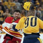 
              Calgary Flames' Milan Lucic, left, and Nashville Predators' Mark Borowiecki (90) fight in the first period of an NHL hockey game Tuesday, April 26, 2022, in Nashville, Tenn. (AP Photo/Mark Humphrey)
            