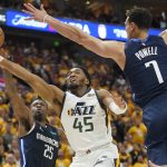 
              Utah Jazz guard Donovan Mitchell (45) goes to the basket as Dallas Mavericks' Reggie Bullock (25) and Dwight Powell (7) defend in the second half of Game 4 of an NBA basketball first-round playoff series, Saturday, April 23, 2022, in Salt Lake City. (AP Photo/Rick Bowmer)
            