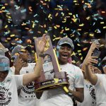 
              South Carolina's Aliyah Boston holds the trophy after a college basketball game in the final round of the Women's Final Four NCAA tournament against UConn Sunday, April 3, 2022, in Minneapolis. South Carolina won 64-49 to win the championship. (AP Photo/Eric Gay)
            