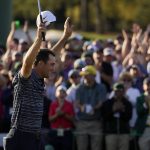 
              Scottie Scheffler celebrates after winning the 86th Masters golf tournament on Sunday, April 10, 2022, in Augusta, Ga. (AP Photo/Jae C. Hong)
            