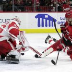
              Detroit Red Wings goaltender Alex Nedeljkovic (39) stops a shot by Carolina Hurricanes center Sebastian Aho (20) during the second period of an NHL hockey game Thursday, April 14, 2022, in Raleigh, N.C. (AP Photo/Chris Seward)
            