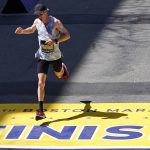 
              Scott Fauble, of the United States, crosses the finish line of the Boston Marathon, Monday, April 18, 2022, in Boston. Fauble, the top American runner, finished seventh. (AP Photo/Charles Krupa)
            