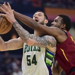 
              Milwaukee Bucks forward Sandro Mamukelashvili attempts to catch a pass while being defended by Cleveland Cavaliers center Evan Mobley, right, in the first half of an NBA basketball game, Sunday, April 10, 2022, in Cleveland. (AP Photo/David Dermer)
            