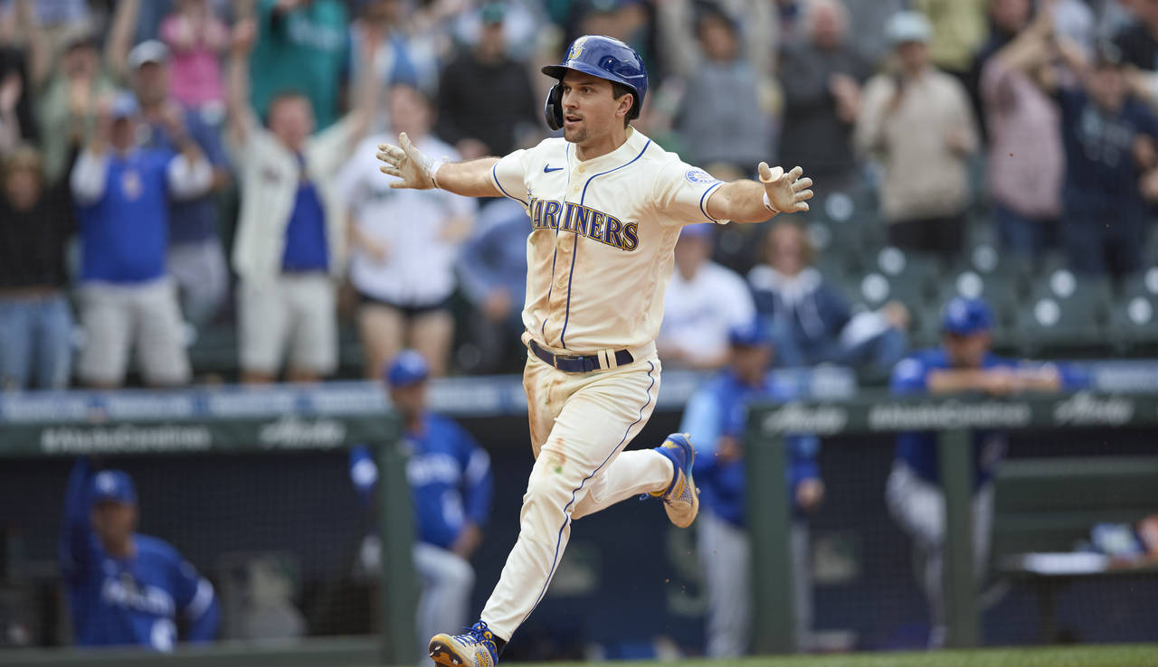 Seattle Mariners' Adam Frazier scores the winning run in the 12th inning against the Kansas City Ro...