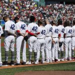 
              The Boston Red Sox line up on the base line wearing the number 42 in honor of Jackie Robinson before a baseball game against the Minnesota Twins, Friday, April 15, 2022, in Boston. (AP Photo/Michael Dwyer)
            