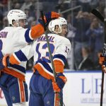 
              New York Islanders center Mathew Barzal (13) and defenseman Noah Dobson (8) celebrate after Barzal scored a goal during the first period of an NHL hockey game against the Buffalo Sabres on Saturday, April 23, 2022, in Buffalo, N.Y. (AP Photo/Joshua Bessex)
            