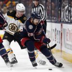 
              Columbus Blue Jackets forward Oliver Bjorkstrand, right, controls the puck in front of Boston Bruins defenseman Mike Reilly during an NHL hockey game in Columbus, Ohio, Monday, April 4, 2022. (AP Photo/Paul Vernon)
            