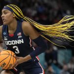 
              UConn's Aaliyah Edwards grabs the ball during the first half of a college basketball game in the semifinal round of the Women's Final Four NCAA tournament Friday, April 1, 2022, in Minneapolis. (AP Photo/Eric Gay)
            
