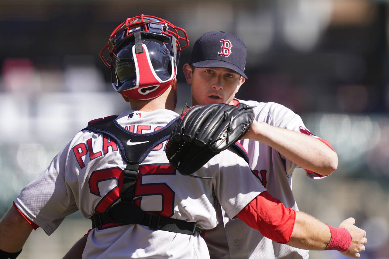 Boston Red Sox relief pitcher Garrett Whitlock hugs catcher Kevin Plawecki after the ninth inning o...
