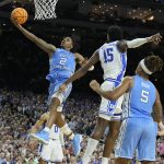 
              North Carolina guard Caleb Love (2) shoots past Duke center Mark Williams (15) during the second half of a college basketball game in the semifinal round of the Men's Final Four NCAA tournament, Saturday, April 2, 2022, in New Orleans. (AP Photo/Brynn Anderson)
            