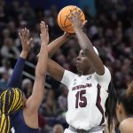 
              South Carolina's Laeticia Amihere shoots over UConn's Aaliyah Edwards during the first half of a college basketball game in the final round of the Women's Final Four NCAA tournament Sunday, April 3, 2022, in Minneapolis. (AP Photo/Charlie Neibergall)
            