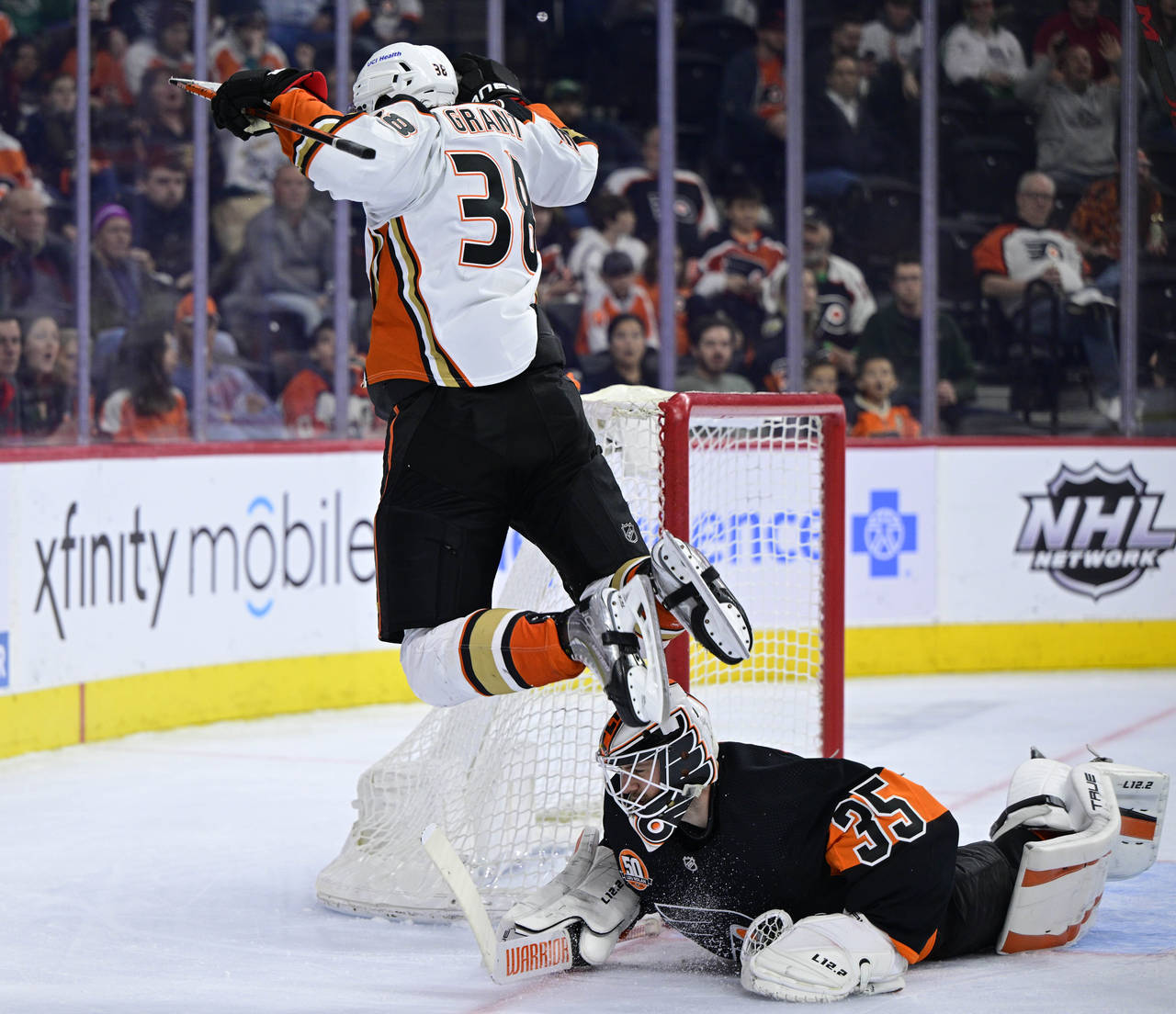 Anaheim Ducks' Derek Grant, left, jumps to avoid running into Philadelphia Flyers goaltender Martin...