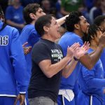 
              Dallas Mavericks team owner Mark Cuban, center, and players on the bench cheer on their team's play against the Utah Jazz in the first half of Game 2 of an NBA basketball first-round playoff series, Monday, April 18, 2022, in Dallas. (AP Photo/Tony Gutierrez)
            