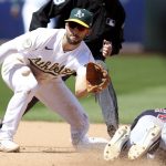 
              Cleveland Guardians' Oscar Mercado (35) is tagged out by Oakland Athletics Kevin Smith, left, on a steal-attempt during the seventh inning of a baseball game in Oakland, Calif., Saturday, April 30, 2022. (AP Photo/Jed Jacobsohn)
            