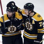 
              Boston Bruins' Erik Haula (56) celebrates his goal with teammate Charlie McAvoy (73) during the first period of an NHL hockey game against the Columbus Blue Jackets, Saturday, April 2, 2022, in Boston. (AP Photo/Michael Dwyer)
            