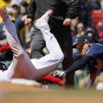 
              Boston Red Sox's Rafael Devers, left, beats the tag from Minnesota Twins' Gio Urshela (15) at third base on a double by Xander Bogaerts during the sixth inning of a baseball game, Monday, April 18, 2022, in Boston. (AP Photo/Michael Dwyer)
            